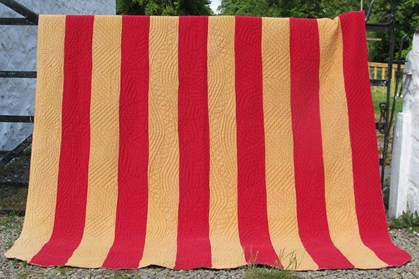 Red and sand strippy quilt