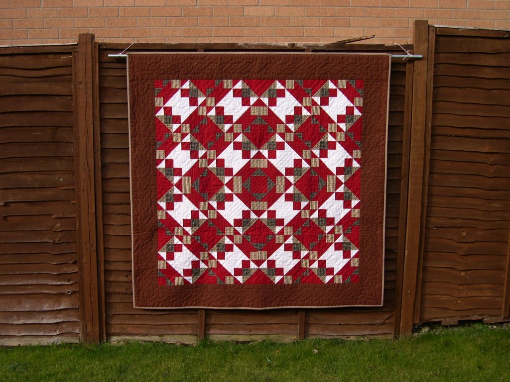 Red brown and white patchwork quilt