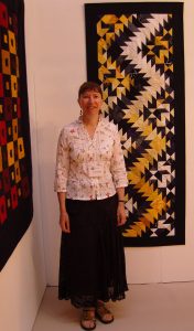 Carolyn with her quilt named Thunderstorm