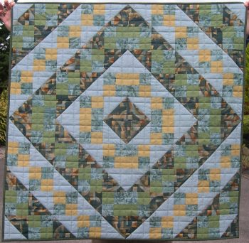 Muted green and apricot quilt