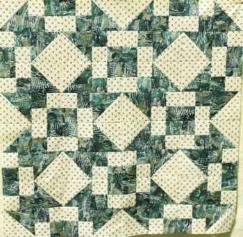 Green and cream quilt