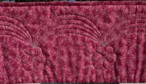 Quilted border design of swags with pansies