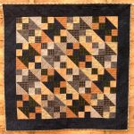 Brown, black and grey small quilt using the Northerrn Lights block