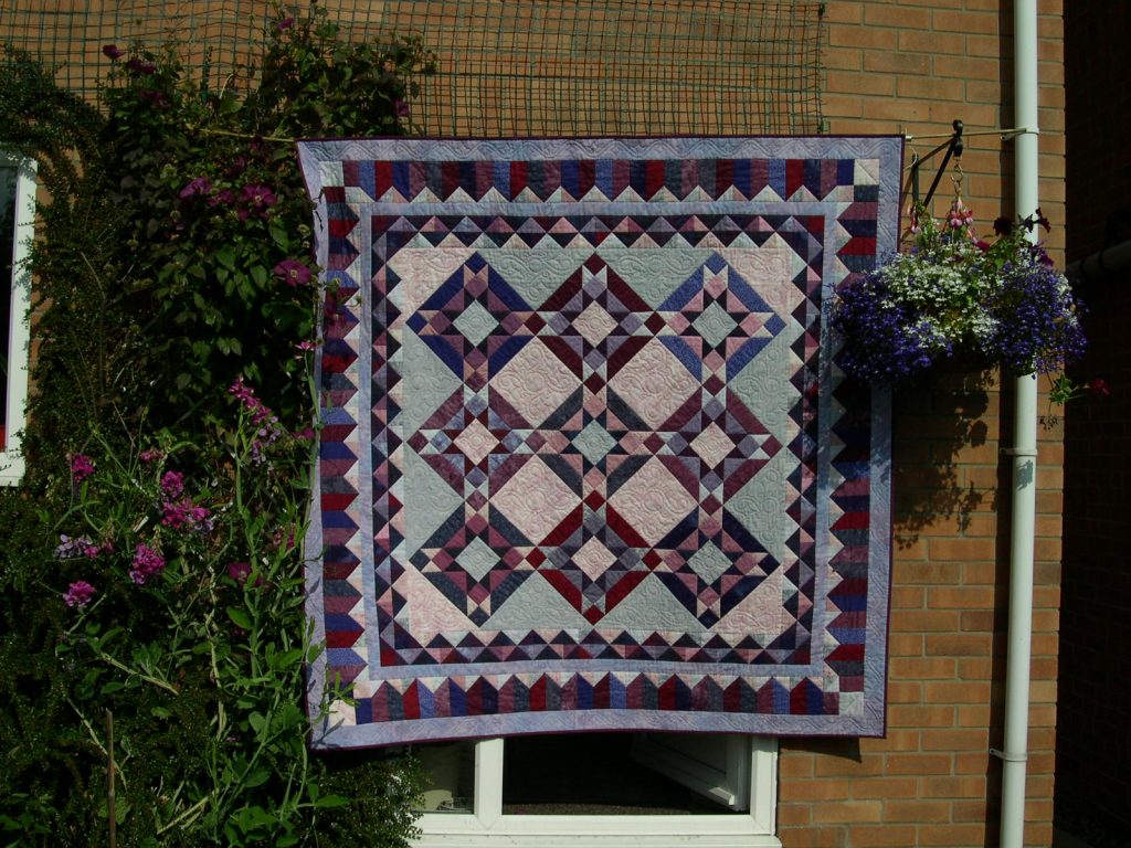 Large bed patchwork quilt in pink & purple