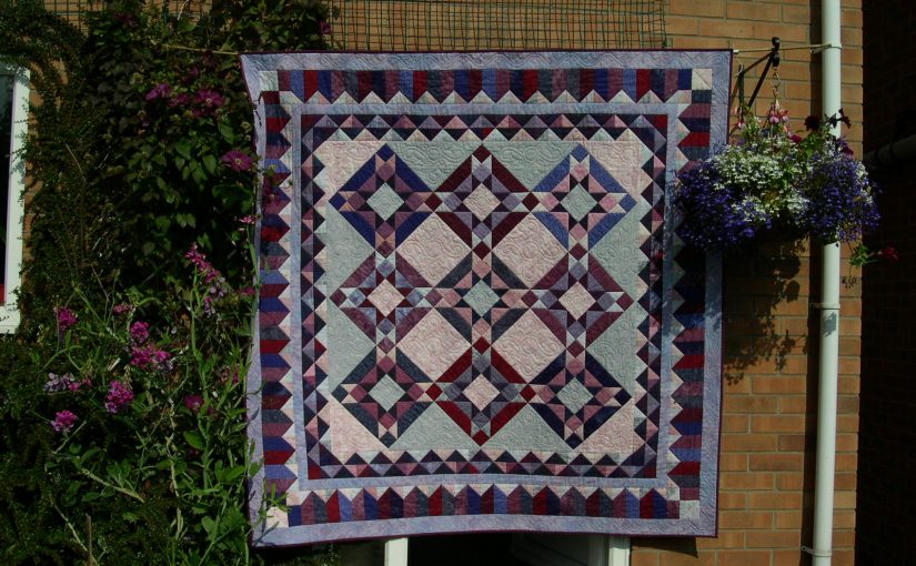 Large bed patchwork quilt in pink & purple