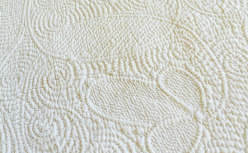 Close-up of acorn motif on corded quilt
