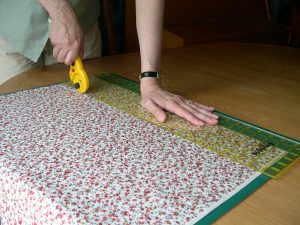 Cutting fabric using a rotary cutter