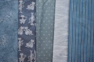 Different colours of pale blue-green fabrics