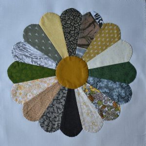 Circular patchwork design made up of yellow and green petals