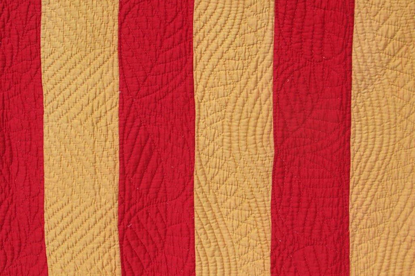 Red and pale gold strips of fabric.