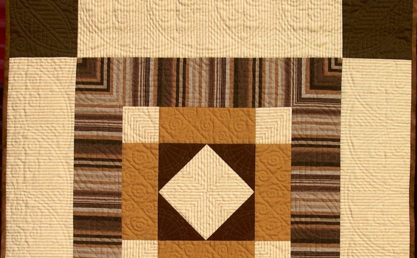 Brown and cream quilt with Welsh hand quilting motifs