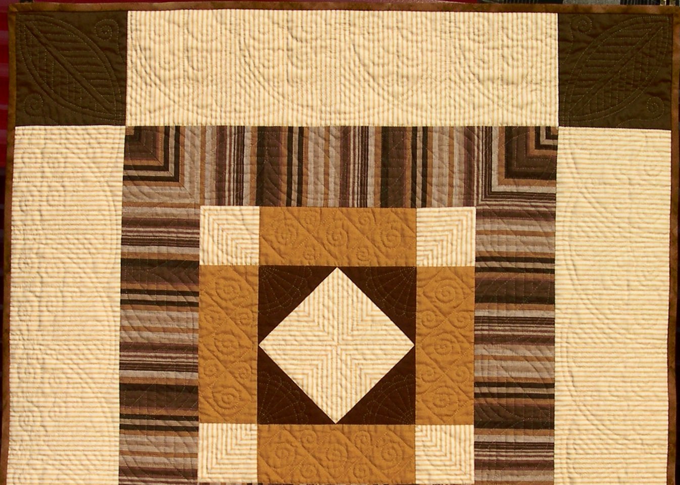 Brown and cream quilt with Welsh hand quilting motifs