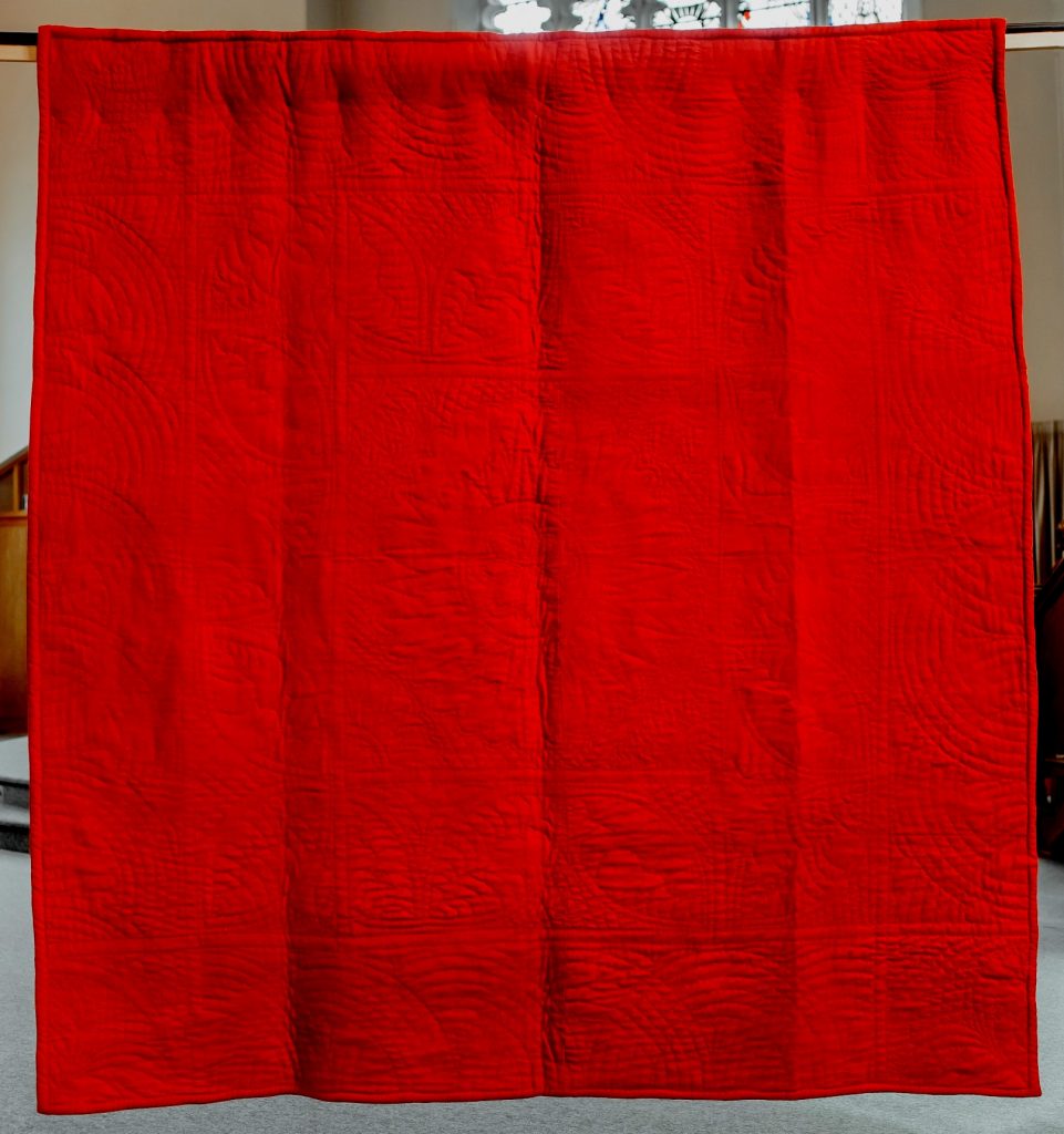 Bright red woollen quilt