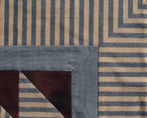 Striped fabrics meet perfectly in border corner