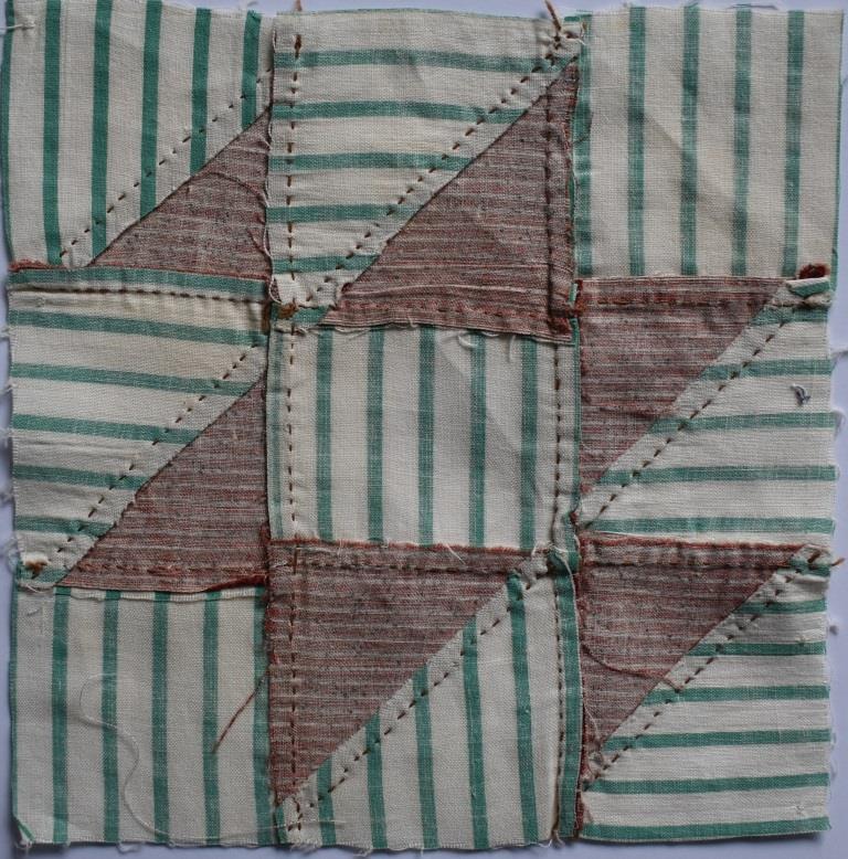 Hand-stitched red and green patchwork block