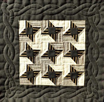 Small quilt with brown and cream stars and cable borderstars