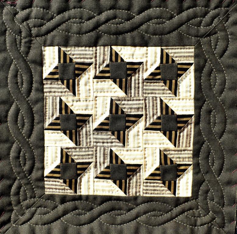 Small quilt with brown and cream stars and cable borderstars