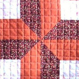 Quilted grid over patchwork avoiding seams.