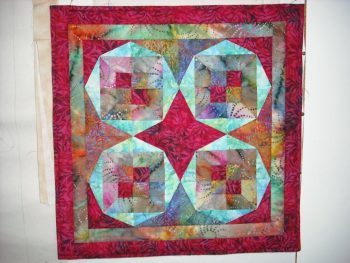 Brightly coloured patchwork design with circles