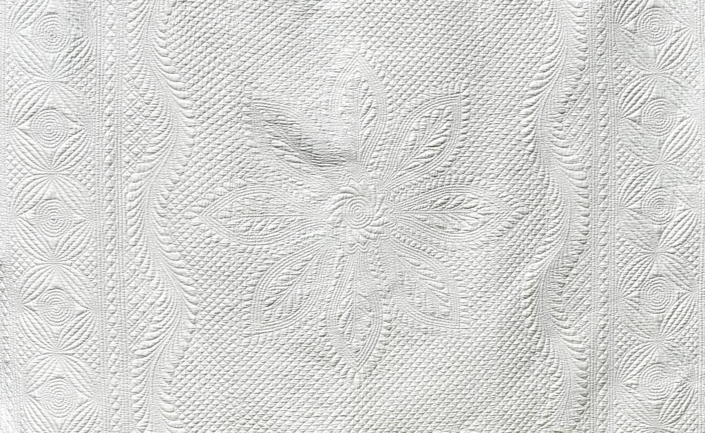 White hand quilted motifs