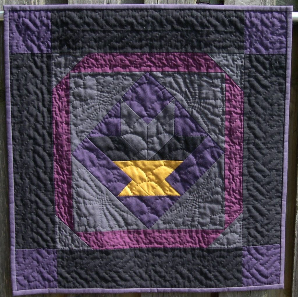 Black, purple and grey basket design with hand quilting