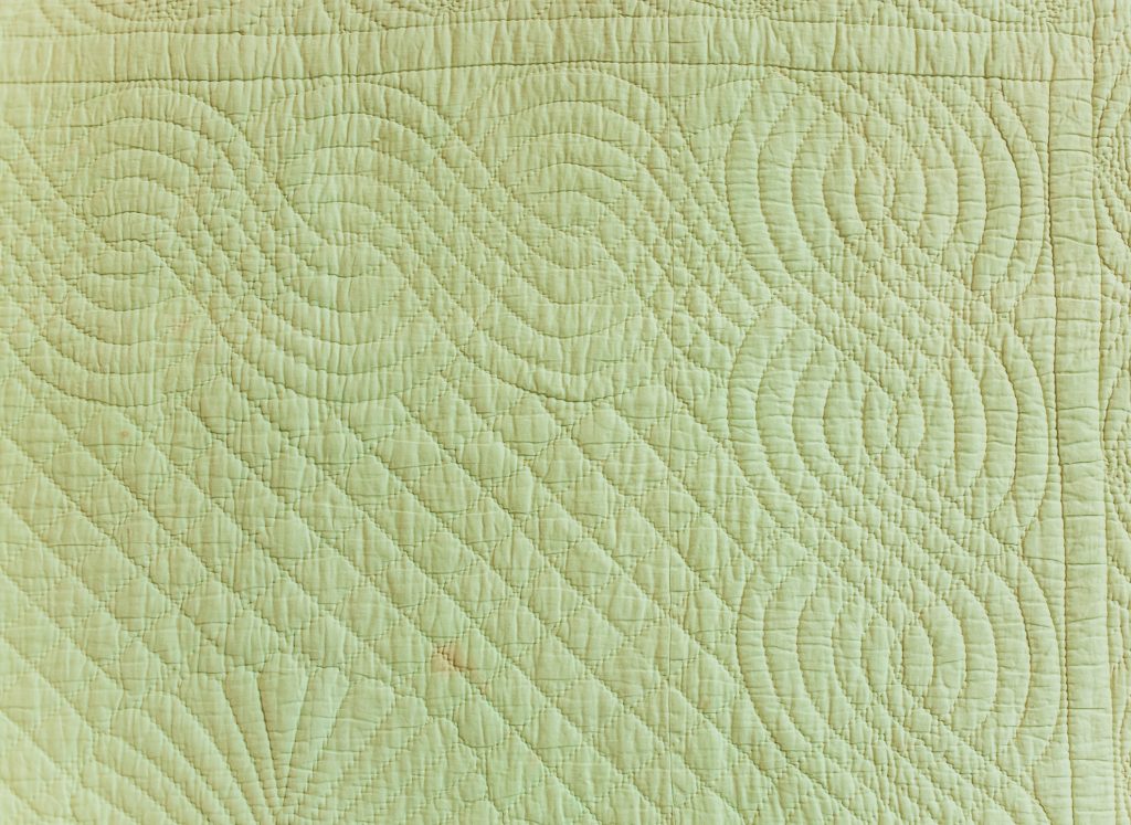 Cable border on green quilt