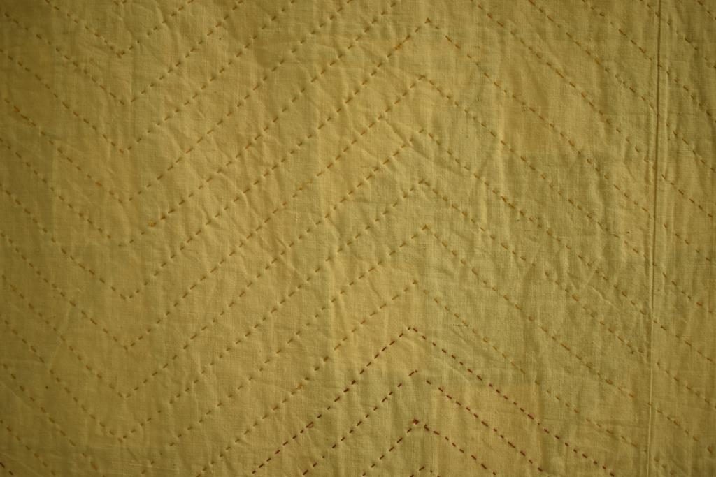 Parallel zig-zag stitched lines, mostly yellow, but changing to red