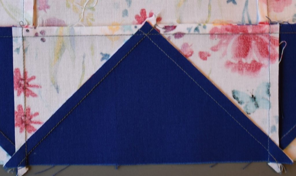 Patchwork with seam pressed away from large blue triangle