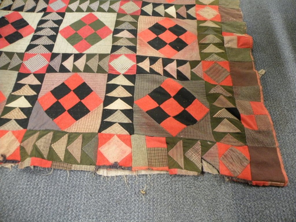 Patchwork with design of squares on right hand side, but showing where a similar border has been cut off on bottom edge.