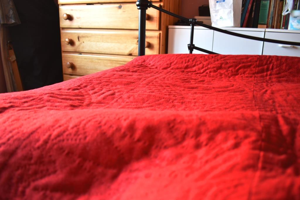 red quilt on bed