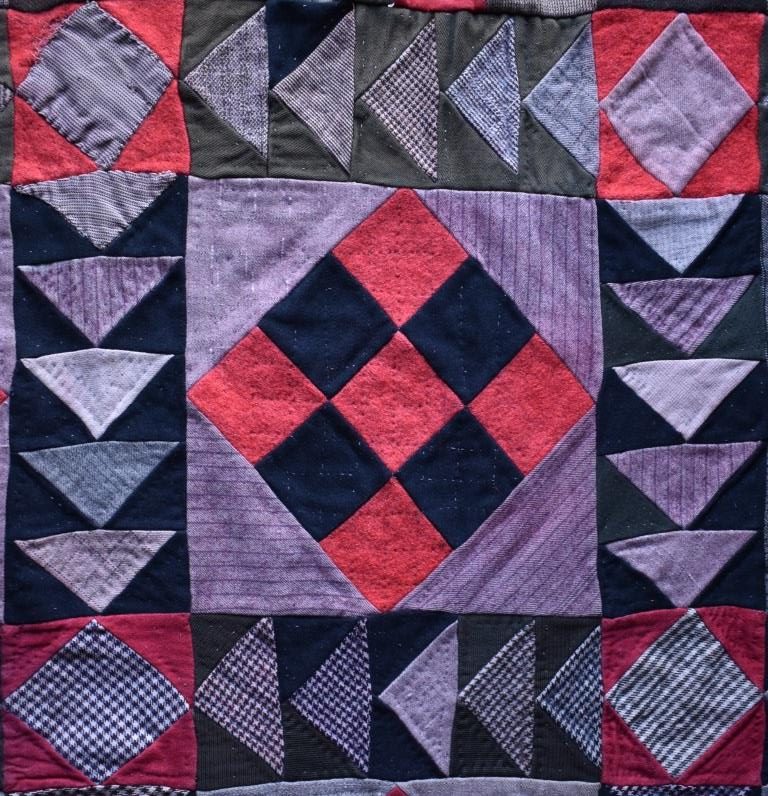 Patchwork in red and black woollen fabrics.