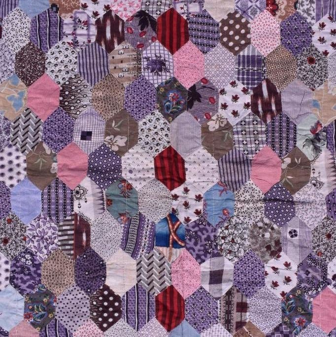 Patchwork hexagons in purples and other prints.