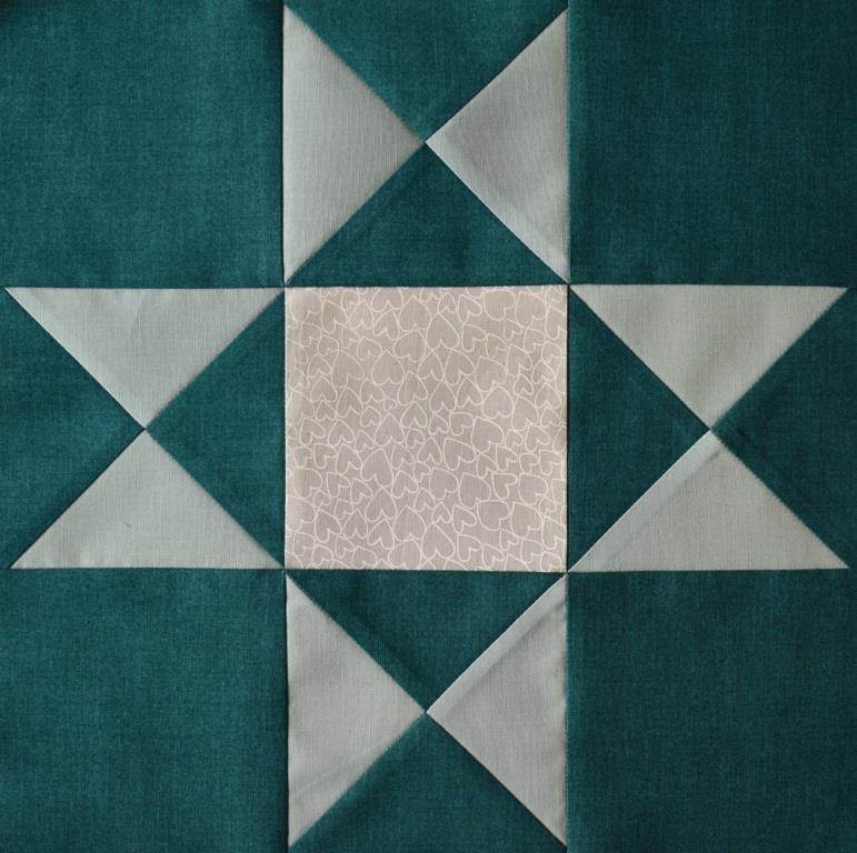 Pale green & white star on dark jade background