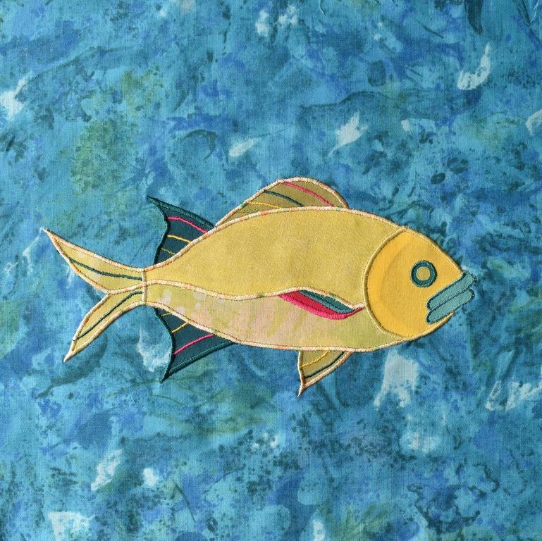 Yellow fish appliqued onto turquoise background