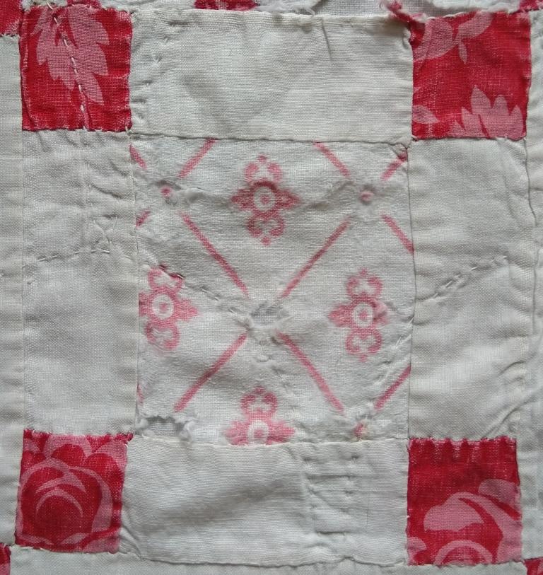 Nine-patch patchwork block with larger pink printed centre