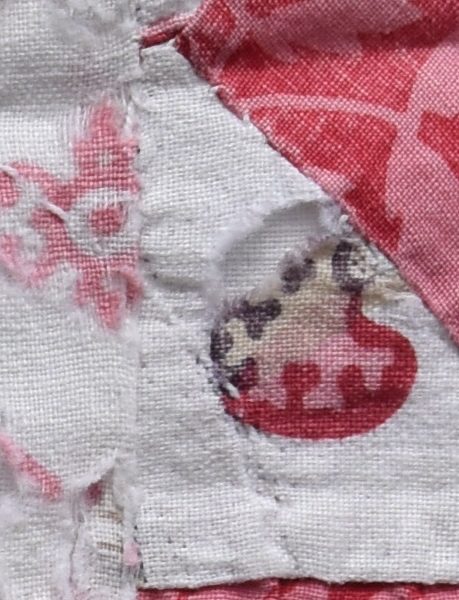 Close-up of printed fabric showing brown, pink and red motif