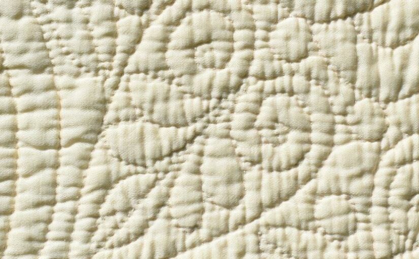 Quilted heart motif on cream cloth